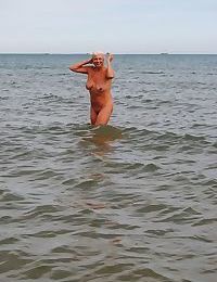 Mature granny Dimonty skinny dipping at the beach with big saggy tits hanging
