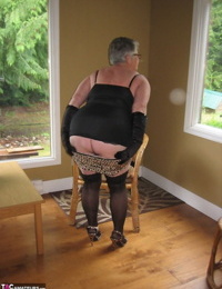 Fat oma Girdle Goddess releases her shaved pussy from her underwear on a chair