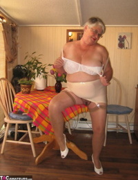 Fat granny Girdle Goddess exposes her huge boobs in a girdle and nylons