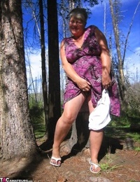 Fat granny Girdle Goddess loses her purple outfit in the woods and poses nude