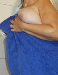 Amateur grandmother Caro removes her wet clothing while taking a shower